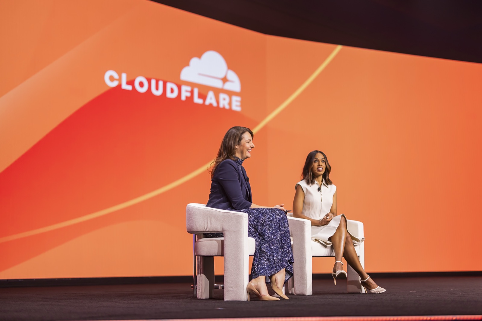 A mainstage fireside chat in front of the Cloudflare logo at Connect 2025